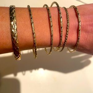Stack of 6 gold bangle bracelets sold all together as a set